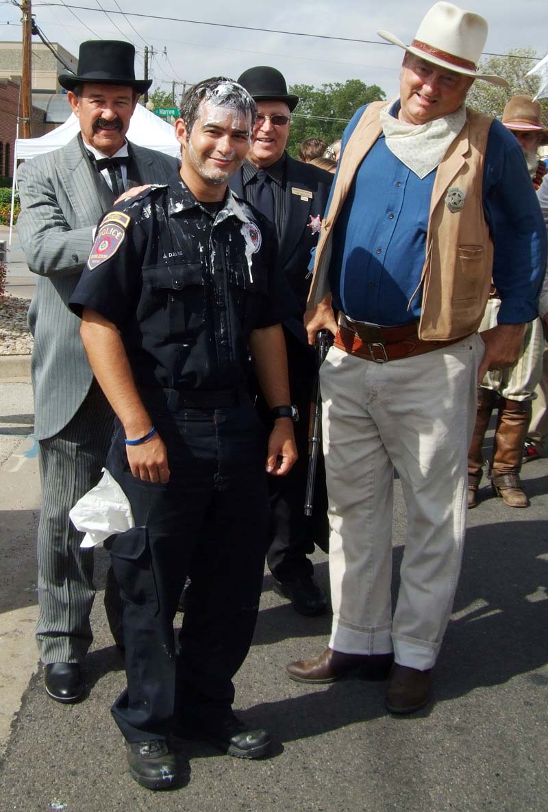 photo of police officer and people in costumes
